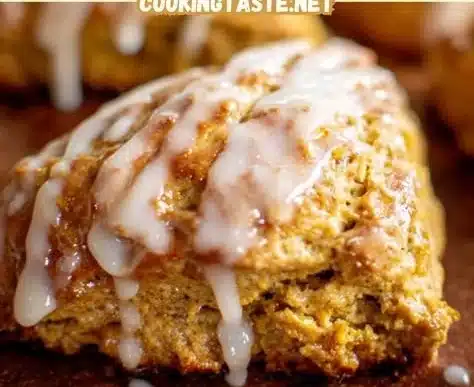 Pumpkin scones topped with a maple glaze, showcasing autumn flavors.