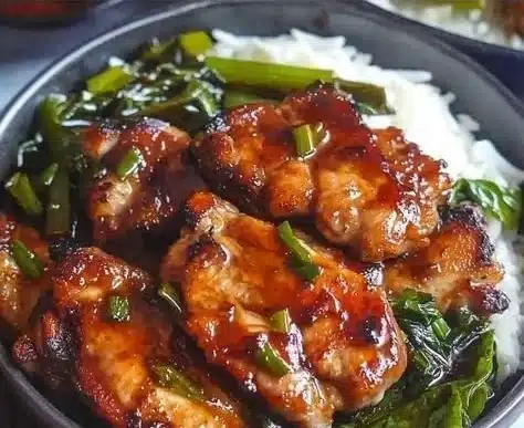 Plate of scallion chicken chops garnished with scallions and served with vegetables