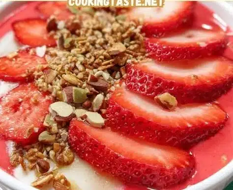 Delicious strawberry smoothie bowl topped with fresh fruits and granola