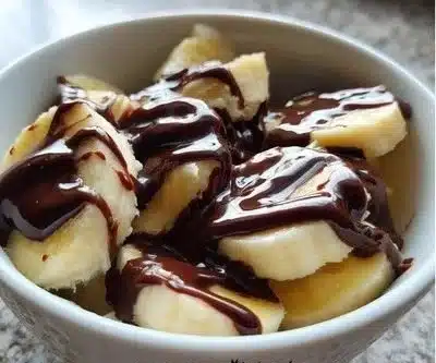 Delicious banana chocolate dessert served in a bowl with a slice of banana on top
