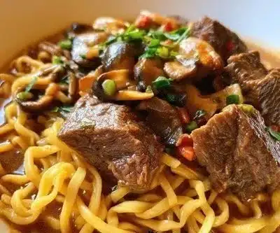 Delicious plate of beef and noodles garnished with herbs and spices