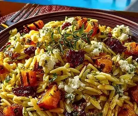 Colorful fall harvest orzo salad with seasonal vegetables and dressing