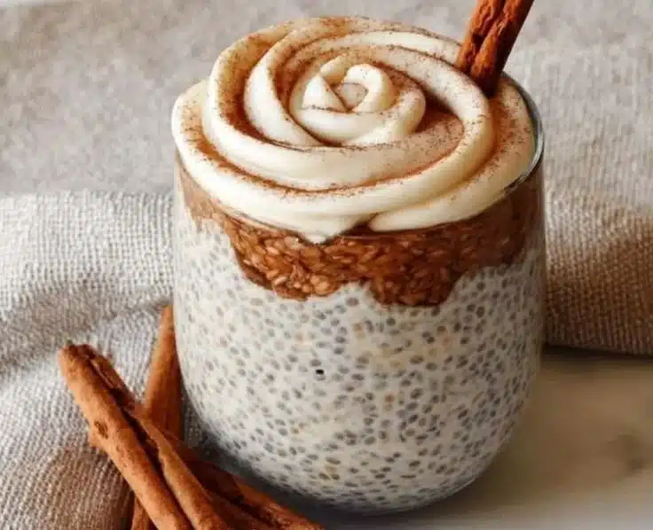 Delicious cinnamon roll overnight oats in a jar topped with cinnamon and nuts