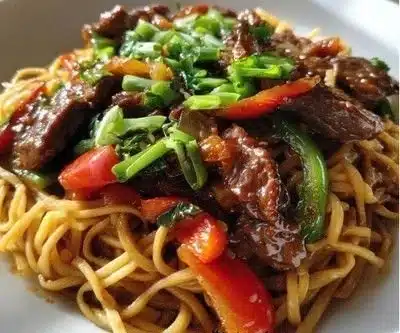 Bowl of Hoisin Beef Noodles with colorful vegetables and beef slices