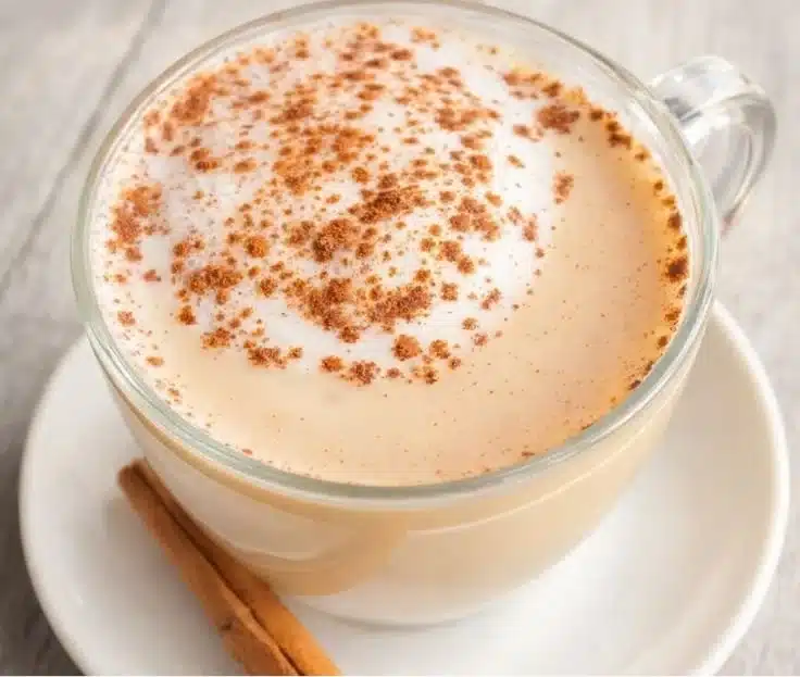 A cozy cup of homemade vanilla cinnamon milk tea with steaming aromas.