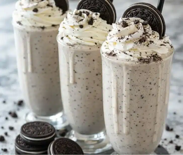 Delicious Oreo Milkshake in a glass with whipped cream and crushed Oreos on top