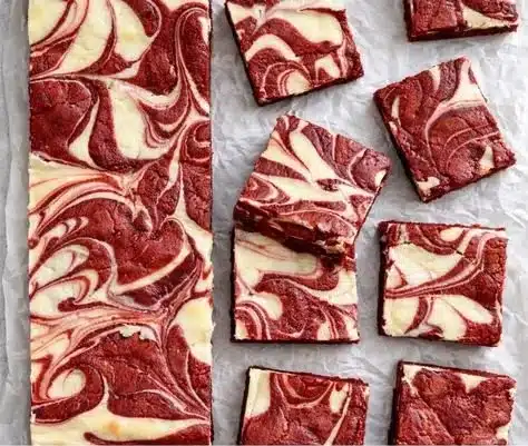 Decadent red velvet cheesecake brownies with creamy cheesecake layer