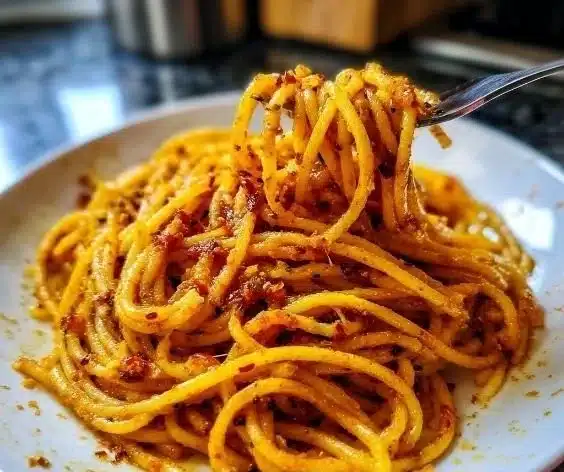 Charred spicy pasta dish, Spaghetti of the Assassin, with intense flavors and vibrant presentation.