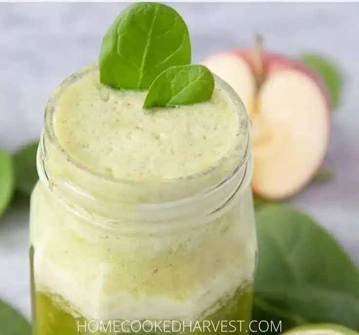 A delicious banana pineapple smoothie in a glass with fresh fruits beside it