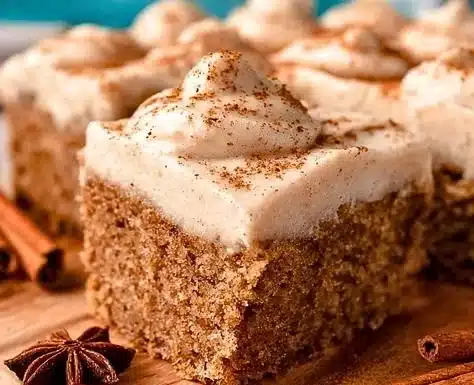 Delicious Chai Cake topped with spices and cream icing served on a rustic plate