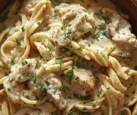 Creamy ricotta chicken pasta served in a bowl with fresh herbs.