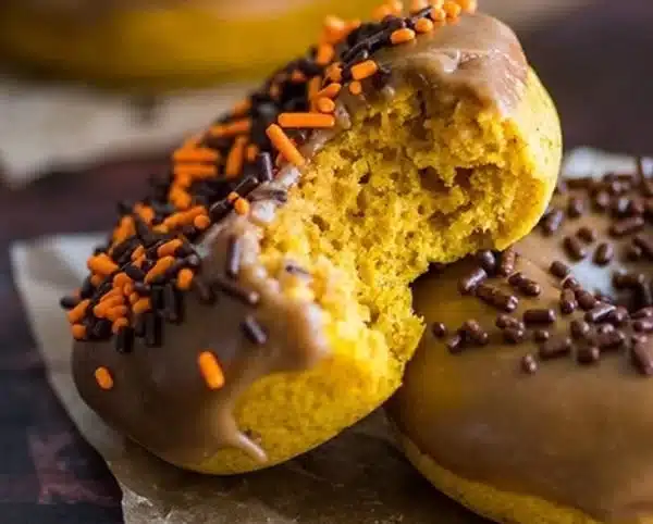 Maple glazed pumpkin donuts on a white plate