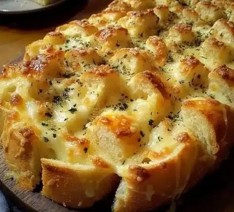 Golden brown party cheese bread topped with melted cheese and herbs.