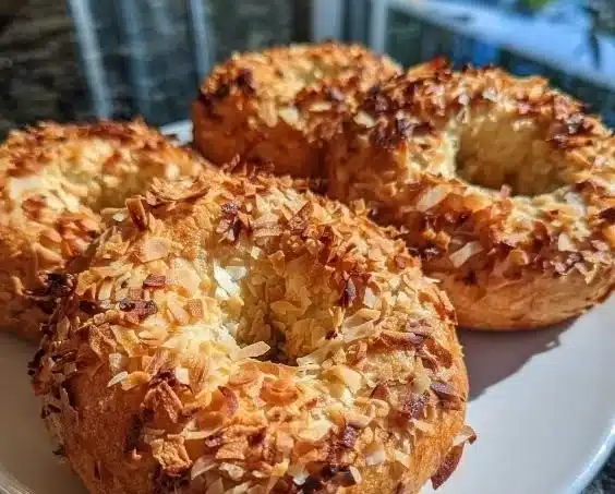 Protein Bagels topped with coconut flakes on a wooden table