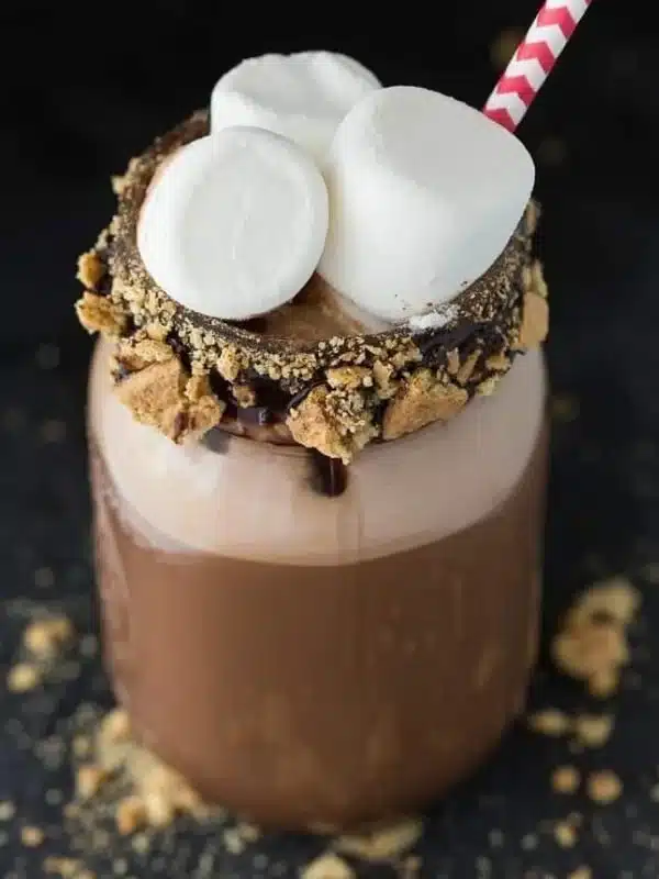 Delicious S'mores Coffee Milkshake topped with whipped cream and chocolate drizzle