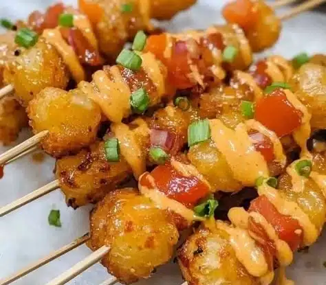 Delicious Tater Tot Kabobs served on skewers with dipping sauce